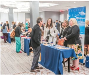 Physician recruiters talking to a candidate at a PracticeLink Live! Physician Career Fair